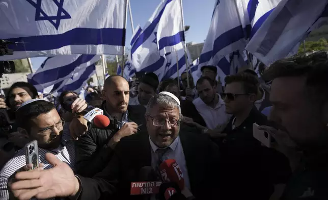 FILE - Israeli lawmaker Itamar Ben-Gvir, center, speaks to the media surrounded by right wing activists as they gather for a march in Jerusalem, April 20, 2022. Ben-Gvir visited Jerusalem’s most sensitive holy site Thursday, July 18, 2024, a move that could threaten the delicate Gaza cease-fire talks. (AP Photo/Ariel Schalit, File)