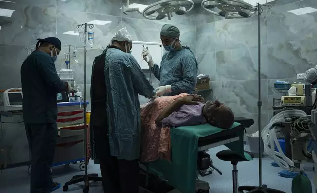 FILE - Dr. Suhaib Alhamss, the director of the Kuwaiti Hospital in Gaza's southern town of Rafah, performs surgery on a patient during his work day on Jan. 11, 2024. (AP Photo/Fatima Shbair, File)