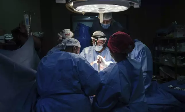 FILE - Doctors perform surgery on a patient at Al-Aqsa Martyrs Hospital, in Deir al-Balah, central Gaza, on March 17, 2024. (AP Photo/Abdel Kareem Hana, File)