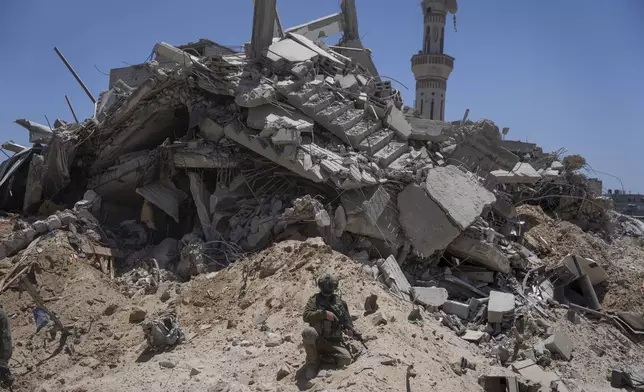 Israeli soldiers walk in the southern Gaza Strip, Wednesday, July 3, 2024. The Israeli military invited reporters for a tour of Rafah, where the military has been operating since May 6. (AP Photo/Ohad Zwigenberg, Pool)