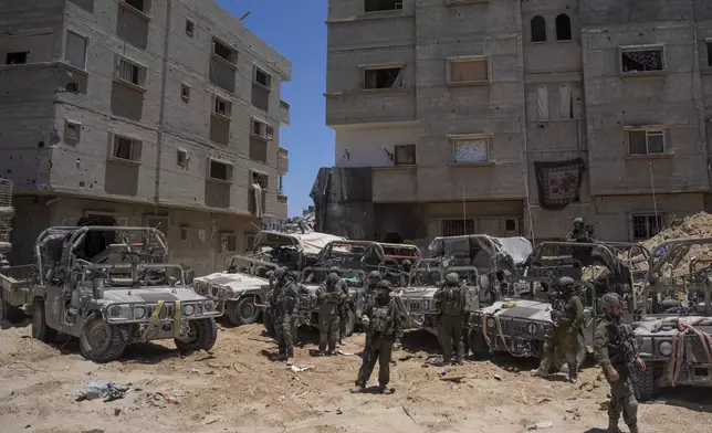 Israeli soldiers gather in the southern Gaza Strip, Wednesday, July 3, 2024. The Israeli military invited reporters for a tour of Rafah, where the military has been operating since May 6. (AP Photo/Ohad Zwigenberg, Pool)