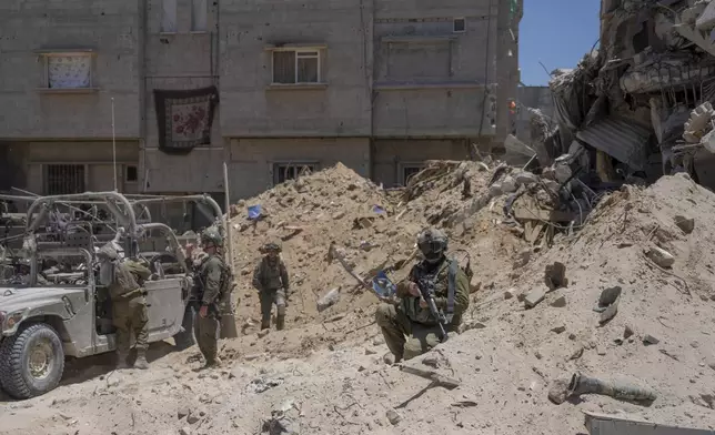 Israeli soldiers gather in the southern Gaza Strip, Wednesday, July 3, 2024. The Israeli military invited reporters for a tour of Rafah, where the military has been operating since May 6. (AP Photo/Ohad Zwigenberg, Pool)