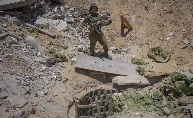 Israeli military spokesperson, Rear Adm. Daniel Hagari, speaks to the media next to the entrance of a tunnel that the military says Hamas militants used in the southern Gaza Strip, Wednesday, July 3, 2024. Israel says that Hamas has booby-trapped tunnel shafts, roads and buildings in the area. The Israeli military invited reporters for a tour of Rafah, where the military has been operating since May 6. (AP Photo/Ohad Zwigenberg, Pool)