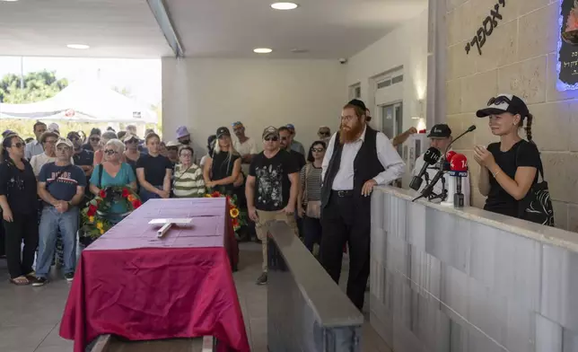 Family and friends of Yevgeny Ferde attend his funeral at a cemetery in Rishon Lezion, Israel, on Sunday, July 21, 2024. Yevgeny Ferde was killed in central Tel Aviv by an explosive drone launched by the Yemeni Houthi militant group. (AP Photo/Ohad Zwigenberg)