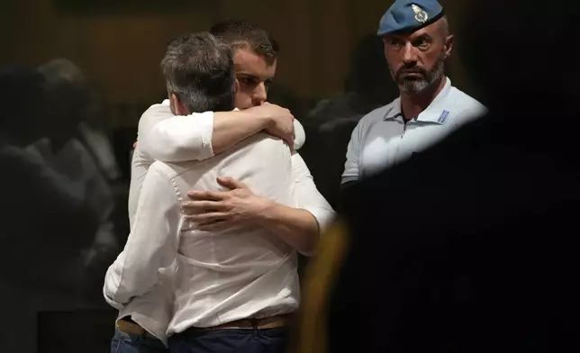 Gabriel Natale Hjorth is hugged by a relative after the reading of the judgment at the end of a hearing for the appeals trial in which he is facing murder charges for killing Italian Carabinieri paramilitary police officer Mario Cerciello Rega, in Rome, Wednesday, July 3, 2024. (AP Photo/Alessandra Tarantino)