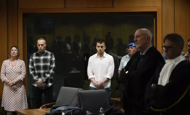 Finnegan Lee Elder, second from left, and Gabriel Natale Hjorth, third from left, listen to the reading of the judgment at the end of a hearing for the appeals trial in which they are facing murder charges for killing Italian Carabinieri paramilitary police officer Mario Cerciello Rega, in Rome, Wednesday, July 3, 2024. (AP Photo/Alessandra Tarantino)