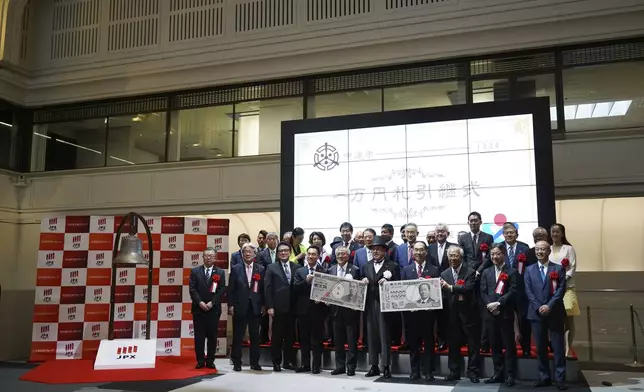 Officials attend the "10,000 Yen Bill Handover Ceremony" at Tokyo Stock Exchange Wednesday, July 3, 2024, in Tokyo. Newly designed banknotes, 10,000 yen (about US$61), 5,000 yen (about US$30) and 1,000 yen (about US$6) went into circulation Wednesday for the first time in 20 years. (AP Photo/Eugene Hoshiko)