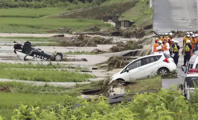 A police vehicle is seen overturned following a heavy rain in Shinjo, Yamagata prefecture, northern Japan Friday, July 26, 2024. Heavy rain hit northern Japan Thursday, triggering floods and landslides, disrupting transportation systems and forcing hundreds of residents to take shelter at safer grounds. (Kyodo News via AP)