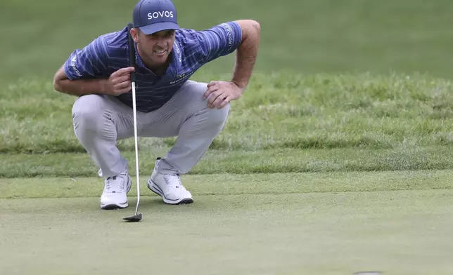 Denny McCarthy lines up his putt on the seventh hole at the John Deere Classic golf tournament Friday, July 5, 2024, at TPC Deere Run in Silvis, Ill. (Roy Dabner/Quad City Times via AP)