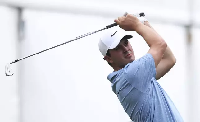 Davis Thompson follows through on his seventh hole tee shot at the John Deere Classic golf tournament Friday, July 5, 2024, at TPC Deere Run in Silvis, Ill. (Roy Dabner/Quad City Times via AP)