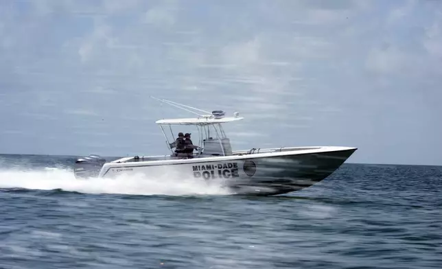 Officers with the Miami-Dade County Police Department's Marine Patrol ply the waters, Wednesday, July 3, 2024, near Key Biscayne, Fla. Elected officials and law enforcement agencies urged boaters not to drink and drive, check the weather before going out and to consider taking a boater safety course during a news conference ahead of the holiday weekend. (AP Photo/Wilfredo Lee)