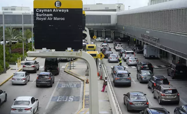 Vehicles drive along the departures area at Miami International Airport, Wednesday, July 3, 2024, in Miami. (AP Photo/Lynne Sladky)