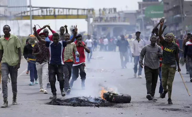 Protesters block the busy Nairobi - Mombasa highway in the Mlolongo area, Nairobi, Kenya Tuesday, July 2, 2024. Protests have continued to rock several towns in Kenya including the capital Nairobi, despite the president saying he will not sign a controversial finance bill that sparked deadly protests last week. (AP Photo/Brian Inganga)