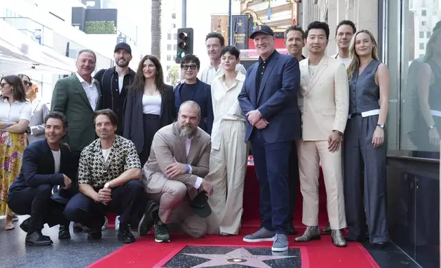 Shawn Levy, from left, Louis D'Esposito, Sebastian Stan, Chris Evans, Kathryn Hahn, David Harbour, Ke Huy Quan, Hugh Jackman, Emma Corrin, Kevin Feige, Ryan Reynolds, Simu Liu, Chris Pratt and Brie Larson attend a ceremony honoring Feige with a star on the Hollywood Walk of Walk of Fame on Thursday, July 25, 2024, in Los Angeles. (Photo by Jordan Strauss/Invision/AP)