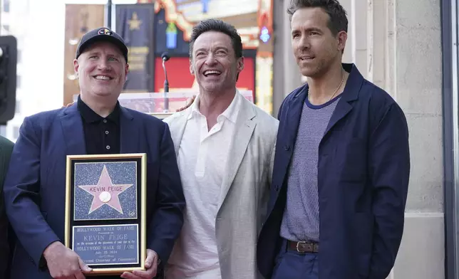 Kevin Feige, from left, Hugh Jackman and Ryan Reynolds attend a ceremony honoring Feige with a star on the Hollywood Walk of Walk of Fame on Thursday, July 25, 2024, in Los Angeles. (Photo by Jordan Strauss/Invision/AP)