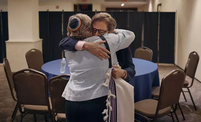 Rabbi Sharon Kleinbaum, right, hugs her wife Randi Weingarten, left, during her last service at the Masonic Hall, on Friday, June 28, 2024, in New York. (AP Photo/ Andres Kudacki)