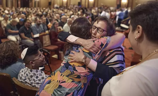 Rabbi Sharon Kleinbaum hugs a worshipper during her last service at the Masonic Hall, Friday, June 28, 2024, in New York. After leading the nation’s largest LGBTQ+ synagogue through the myriad ups and downs of the modern gay-rights movement for the last three decades, she is now stepping down from that role and shifting into retirement. The synagogue that she led for 32 years — Congregation Beit Simchat Torah in midtown Manhattan — will have to grapple with its identity after being defined by its celebrity rabbi for so long. (AP Photo/Andres Kudacki)