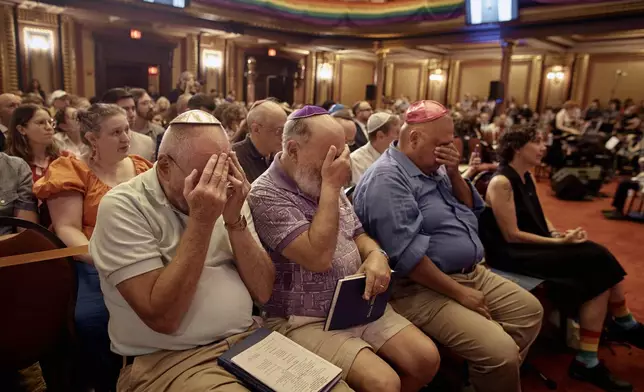 Worshippers pray with Rabbi Sharon Kleinbaum as she speaks during her last service at the Masonic Hall, Friday, June 28, 2024, in New York. (AP Photo/Andres Kudacki)