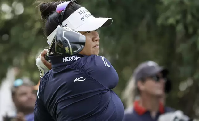 Megan Khang, of the United States, watches her tee shot on the second hole during the second round at the LPGA Canadian Women's Open golf tournament in in Calgary, Alberta, Friday, July 26, 2024. (Jeff McIntosh /The Canadian Press via AP)