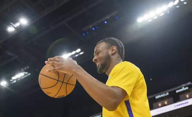 Los Angeles Lakers guard Bronny James dribbles before an NBA summer league basketball game against the Golden State Warriors in San Francisco, Sunday, July 7, 2024. (AP Photo/Nic Coury)