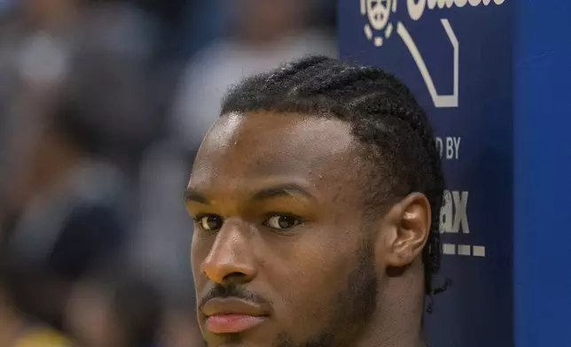 Los Angeles Lakers guard Bronny James watches warmup action before an NBA summer league basketball game against Golden State Warriors in San Francisco , Sunday, July 7, 2024. (AP Photo/Nic Coury)