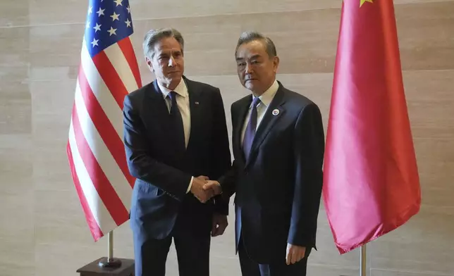 U.S. Secretary of State Antony Blinken, left, shakes hands with Chinese counterpart Wang Yi on the sideline of the Association of Southeast Asian Nations (ASEAN) Foreign Ministers' Meeting in Vientiane, Laos, Saturday, July 27, 2024. (AP Photo/Achmad Ibrahim, Pool)