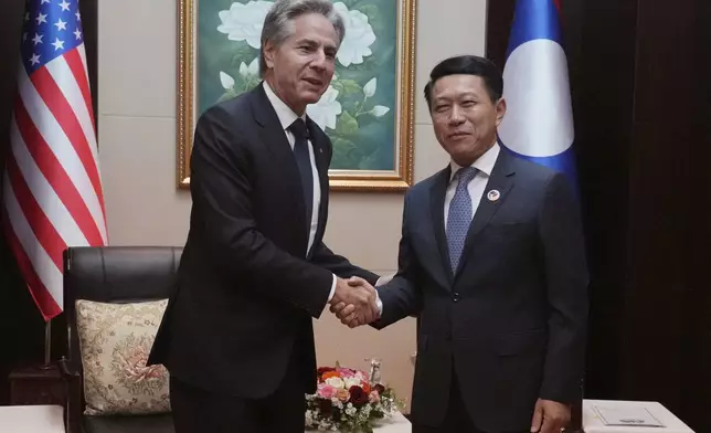 U.S. Secretary of State Antony Blinken, left, shakes hands with Laos Foreign Minister Saleumxay Kommasith during ASEAN Foreign Ministers Meeting (AMM) in Vientiane, Laos, Saturday, July 27, 2024. (AP Photo/Achmad Ibrahim, Pool)