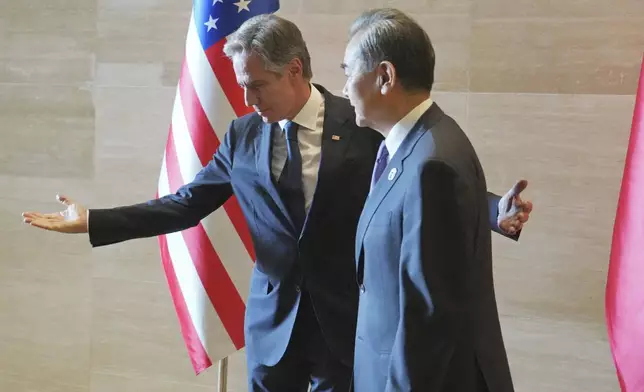 U.S. Secretary of State Antony Blinken, left, gestures to Chinese counterpart Wang Yi on the sideline of the Association of Southeast Asian Nations (ASEAN) Foreign Ministers' Meeting in Vientiane, Laos, Saturday, July 27, 2024. (AP Photo/Achmad Ibrahim, Pool)