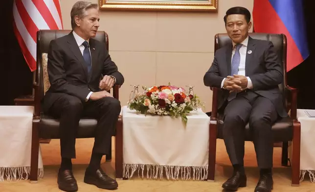 U.S. Secretary of State Antony Blinken, left, talks with Laos Foreign Minister Saleumxay Kommasith during ASEAN Foreign Ministers Meeting (AMM) in Vientiane, Laos, Saturday, July 27, 2024. (AP Photo/Achmad Ibrahim, Pool)