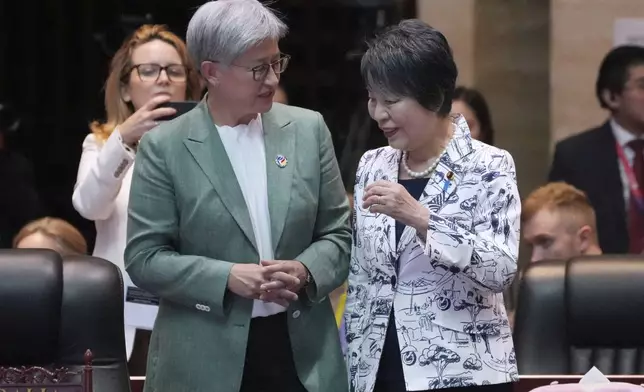 Japan's Foreign Minister Yoko Kamikawa, right, talks with Australian Minister of Foreign Affairs Penny Wong, left, during the East Asia Summit Foreign Ministers' Meeting in Vientiane, Laos, Saturday, July 27, 2024. (AP Photo/Achmad Ibrahim, Pool)