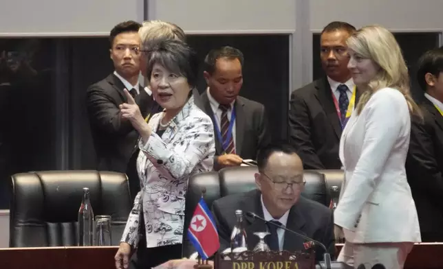 Japan's Foreign Minister Yoko Kamikawa, left, and Canada's Foreign Minister Melanie Joy, right, walk behind North Korea's Ambassador to Laos Ri Yong Chol, bottom center, before the ASEAN Regional Forum Ministerial Meeting in Vientiane, Laos, Saturday, July 27, 2024. (AP Photo/Sakchai Lalit)