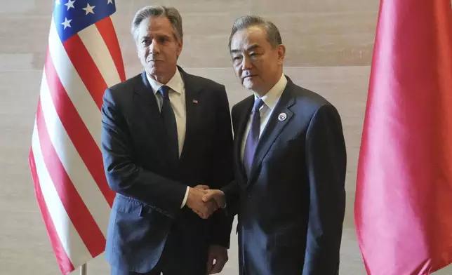 U.S. Secretary of State Antony Blinken, left, shakes hands with Chinese counterpart Wang Yi on the sideline of the Association of Southeast Asian Nations (ASEAN) Foreign Ministers' Meeting in Vientiane, Laos, Saturday, July 27, 2024. (AP Photo/Achmad Ibrahim, Pool)