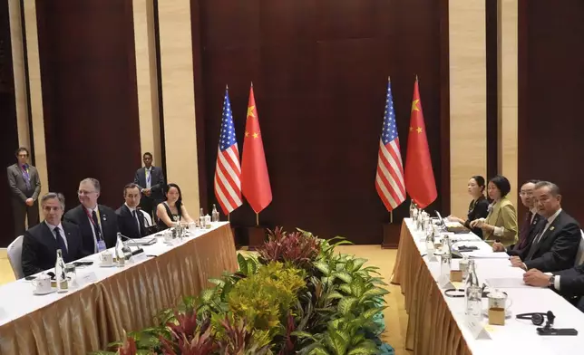 U.S. Secretary of State Antony Blinken, left, and Chinese counterpart Wang Yi, right, hold a talk on the sideline of the Association of Southeast Asian Nations (ASEAN) Foreign Ministers' Meeting in Vientiane, Laos, Saturday, July 27, 2024. (AP Photo/Achmad Ibrahim, Pool)