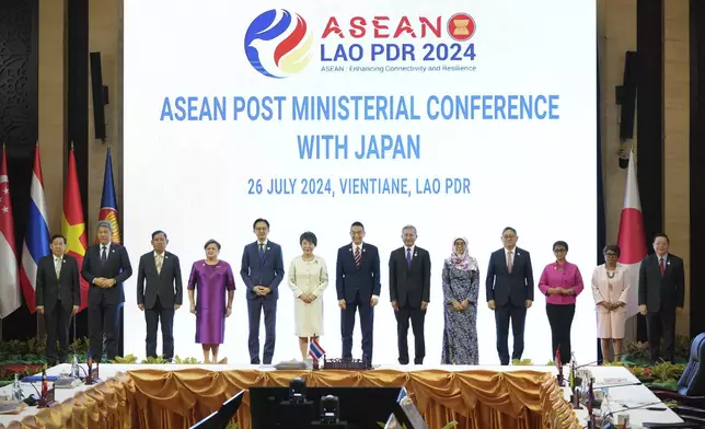 Japan's Foreign Minister Yoko Kamikawa, sixth from left, poses for photos with ASEAN ministers and delegates before the ASEAN Post Ministerial Conference with Japan at the Association of Southeast Asian Nations (ASEAN) Foreign Ministers' Meeting in Vientiane, Laos, Friday, July 26, 2024. (AP Photo/Achmad Ibrahim)