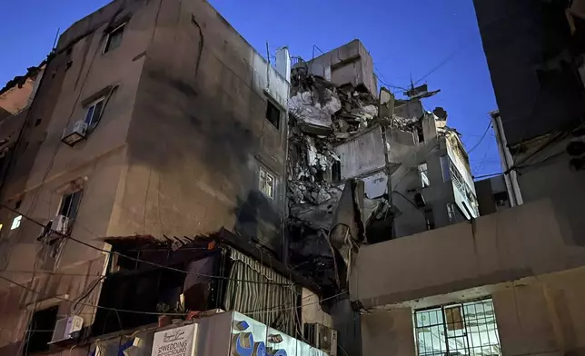 A general view shows a damaged building that was hit by an Israeli airstrike in the southern suburbs of Beirut, Lebanon, Tuesday, July 30, 2024. An Israeli airstrike hit Hezbollah's stronghold south of Beirut Tuesday evening causing damage, a Hezbollah official and the group's TV station said. (AP Photo/Hussein Malla)