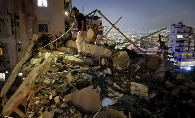 A man inspects a destroyed building that was hit by an Israeli airstrike in the southern suburbs of Beirut, Lebanon, Tuesday, July 30, 2024. An Israeli airstrike hit Hezbollah's stronghold south of Beirut Tuesday evening causing damage, a Hezbollah official and the group's TV station said. (AP Photo/Hussein Malla)