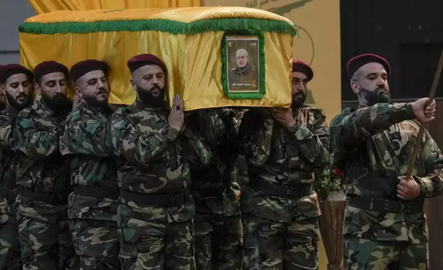 Hezbollah fighters carry the coffin of their comrade, senior commander Mohammad Naameh Nasser, who was killed by an Israeli airstrike that hit his car in the southern costal town of Tyre, during his funeral procession in the southern suburbs of Beirut, Lebanon, Thursday, July 4, 2024. The strike took place as global diplomatic efforts have intensified in recent weeks to prevent escalating clashes between Hezbollah and the Israeli military from spiralling into an all-out war that could possibly lead to a direct confrontation between Israel and Iran. (AP Photo/Bilal Hussein)