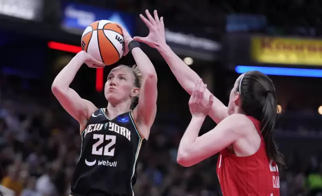 New York Liberty's Courtney Vandersloot (22) shoots over Indiana Fever's Caitlin Clark (22) during the first half of a WNBA basketball game, Saturday, July 6, 2024, in Indianapolis. (AP Photo/Darron Cummings)