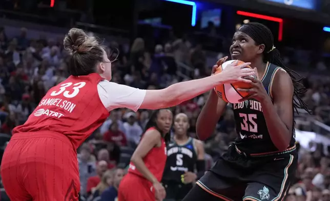 New York Liberty's Jonquel Jones (35) puts up a shot against Indiana Fever's Katie Lou Samuelson (33) during the first half of a WNBA basketball game, Saturday, July 6, 2024, in Indianapolis. (AP Photo/Darron Cummings)