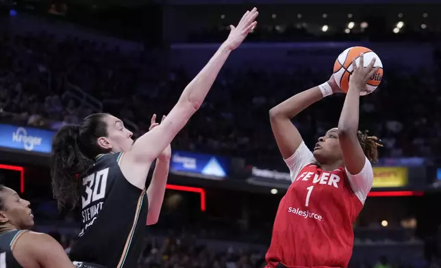 Indiana Fever's NaLyssa Smith (1) shoots over New York Liberty's Breanna Stewart (30) during the second half of a WNBA basketball game, Saturday, July 6, 2024, in Indianapolis. (AP Photo/Darron Cummings)