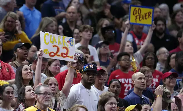 A fan holds up a Indiana Fever's Caitlin Clark sign during the second half of a WNBA basketball game against the New York Liberty, Saturday, July 6, 2024, in Indianapolis. (AP Photo/Darron Cummings)