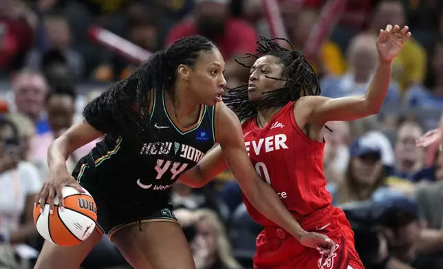 New York Liberty's Betnijah Laney-Hamilton goes to the basket against Indiana Fever's Kelsey Mitchell during the second half of a WNBA basketball game, Saturday, July 6, 2024, in Indianapolis. (AP Photo/Darron Cummings)