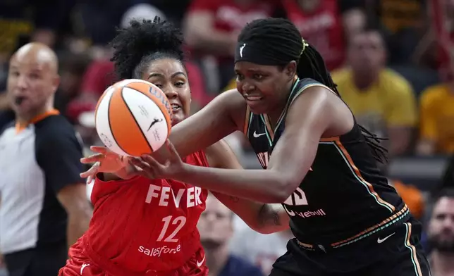 New York Liberty's Jonquel Jones (35) is defended by Indiana Fever's Damiris Dantas (12) during the second half of a WNBA basketball game, Saturday, July 6, 2024, in Indianapolis. (AP Photo/Darron Cummings)