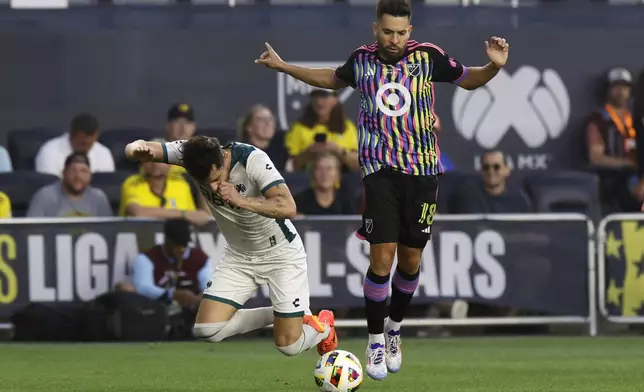 MLS All-Stars' Jordi Alba, right, trips Liga MX All-Stars' Alan Mozo during the first half of the MLS All-Star soccer match Wednesday, July 24, 2024, in Columbus, Ohio. (AP Photo/Jay LaPrete)