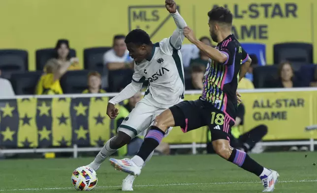 Liga MX All-Stars' Javairo Dilrosun, left, shoots the ball as MLS All-Stars' Jordi Alba defends during the first half of the MLS All-Star soccer match Wednesday, July 24, 2024, in Columbus, Ohio. (AP Photo/Jay LaPrete)