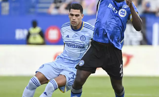 Atlanta United's Daniel Ríos, left, moves in on CF Montreal's Victor Wanyama (2) during the first half of an MLS soccer match in Montreal, Saturday, July 13, 2024. (Graham Hughes/The Canadian Press via AP)