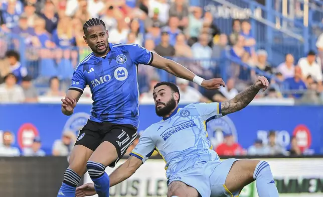 CF Montreal's Ariel Lassiter (11) and Atlanta United's Derrick Williams (3) challenge for the ball during the first half of an MLS soccer match in Montreal, Saturday, July 13, 2024. (Graham Hughes/The Canadian Press via AP)