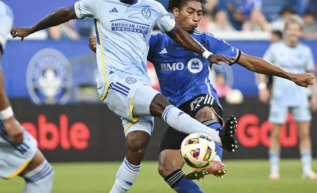 CF Montreal's Nathan-Dylan Saliba (19) and Atlanta United's Xande Silva (16) challenge for the ball during the first half of an MLS soccer match in Montreal, Saturday, July 13, 2024. (Graham Hughes/The Canadian Press via AP)