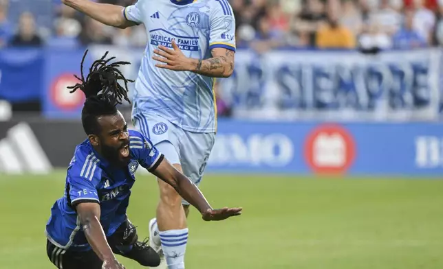 CF Montreal's Raheem Edwards, left, is brought down by Atlanta United midfielder Bartosz Slisz, right, during first-half MLS soccer match action in Montreal, Saturday, July 13, 2024. (Graham Hughes/The Canadian Press via AP)