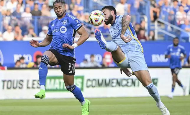 CF Montreal's Ariel Lassiter (11) and Atlanta United's Derrick Williams (3) challenge for the ball during the first half of an MLS soccer match in Montreal, Saturday, July 13, 2024. (Graham Hughes/The Canadian Press via AP)